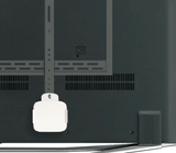 QualGear QG-AM-017-W white mount holding an Apple TV on the back of a TV