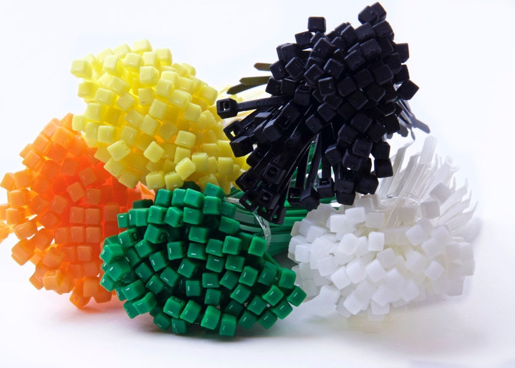 Close-up of yellow, orange, green, black, and white 4 in tie bundles with heads clustered